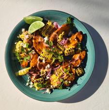 Honey habanero roasted sweet potato and blistered corn salad with pickled red onion, feta, cilantro, and lime dressing.