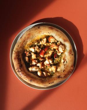 Golden flatbread, miso butter puddle, tender lobster, fresh herbs.